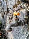 Old house faucet with orange handle top three quarter view Royalty Free Stock Photo