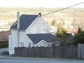 Old house and fence on a hil overlooking the bay Royalty Free Stock Photo