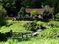 Old house with a field and a creek in front