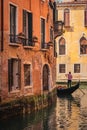 Old house front in venice. A gondolieri leisurely rowing down the canal. Royalty Free Stock Photo