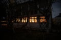 Old house with a Ghost in the forest at night or Abandoned Haunted Horror House in fog. Old mystic building in dead tree forest. Royalty Free Stock Photo