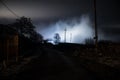 Old house with a Ghost in the forest at night or Abandoned Haunted Horror House in fog. Old mystic building in dead tree forest. Royalty Free Stock Photo