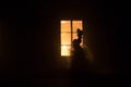 Old house with a Ghost in the forest at night. Horror silhouette at the window. Old building in forest. Surreal lights. Horror Royalty Free Stock Photo