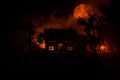 Old house with a Ghost in the moonlit night or Abandoned Haunted Horror House in fog. Old mystic villa with surreal big full moon. Royalty Free Stock Photo