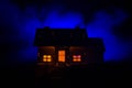 Old house with a Ghost in the moonlit night or Abandoned Haunted Horror House in fog, Old mystic villa with surreal big full moon. Royalty Free Stock Photo