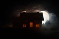 Old house with a Ghost in the moonlit night or Abandoned Haunted Horror House in fog, Old mystic villa with surreal big full moon. Royalty Free Stock Photo