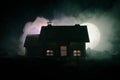 Old house with a Ghost in the moonlit night or Abandoned Haunted Horror House in fog, Old mystic villa with surreal big full moon. Royalty Free Stock Photo