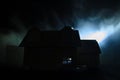 Old house with a Ghost in the moonlit night or Abandoned Haunted Horror House in fog. Old mystic villa with surreal big full moon. Royalty Free Stock Photo