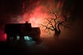 Old house with a Ghost at night with spooky tree or Abandoned Haunted Horror House in toned foggy sky with light. Old mystic build Royalty Free Stock Photo