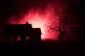 Old house with a Ghost at night with spooky tree or Abandoned Haunted Horror House in toned foggy sky with light. Old mystic build Royalty Free Stock Photo