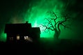 Old house with a Ghost at night with spooky tree or Abandoned Haunted Horror House in toned foggy sky with light. Old mystic build Royalty Free Stock Photo