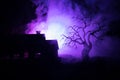 Old house with a Ghost at night with spooky tree or Abandoned Haunted Horror House in toned foggy sky with light. Old mystic build Royalty Free Stock Photo