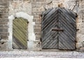 Old house grey brick wall with shutted wooden gates and door Royalty Free Stock Photo