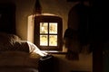 Old house interior, small window, bed and herbs. Open-air museum, skanzen