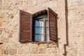 Old house in Israel with windows with brown shutters. Historical building