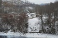 old house lodge in the forest in mountains. From a pipe there is a smoke. Winter landscape. Royalty Free Stock Photo