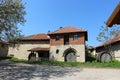 Old house made of stone with wooden door and large barrel