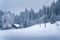 An old house in mountain village buried in snow on a very cold winter day in carpathian mountains, Czech Republic. Power