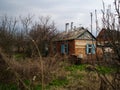 The old house in the overgrown yard. The abandoned house demanding leaving Royalty Free Stock Photo