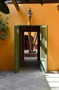 Old house, painted orange, with wooden door painted in green Royalty Free Stock Photo