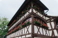 Old house with red geraniums at the windows