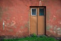 Old house, red wall with grunge old red door, texture Royalty Free Stock Photo