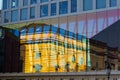 Old house reflected in glass windows of modern skyscraper. Royalty Free Stock Photo