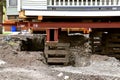 Old house resting on girders and timbers Royalty Free Stock Photo