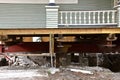 Old house resting on girders and timbers Royalty Free Stock Photo