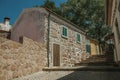 Old house with rough stone wall in an alley with steps Royalty Free Stock Photo