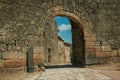 Old house seen through arch gate from a stone wall Royalty Free Stock Photo