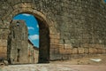 Old house seen through arch gate from a stone wall Royalty Free Stock Photo