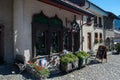 Shop for tourists in an old house with a terrace, flowers and large wooden windows in Gruyeres, Switzerland.