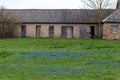 An old house with a small and blue flower garden in front of it Royalty Free Stock Photo