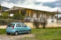 Old house and a small car parked outside