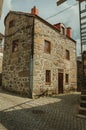 Old house with stone wall in a deserted alley Royalty Free Stock Photo