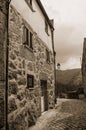 Old house with stone wall in a deserted alley Royalty Free Stock Photo