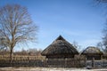 Old house with a straw roof in the blue sky in the spring Royalty Free Stock Photo