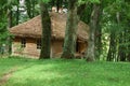 Old house with straw roof in the dense forest