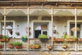 Old House in Tbilisi, Georgia with Beautiful Terrace. Ancient traditional wooden balcony decorated with lot of flowers and old