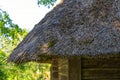 an old house with a thatched roof. ancient technology of house construction