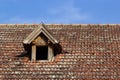 Old house with tile roof on the background of the sky. Texture, roof repair in vintage style Royalty Free Stock Photo