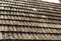 Old house with tile roof on the background of the sky. Texture, roof repair in vintage style Royalty Free Stock Photo