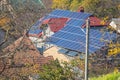 An old house in Ukraine with a red tiled roof lined with solar panels. Photovoltaic panels on the roof. Saving electricity Royalty Free Stock Photo