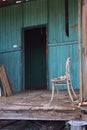 Termite damaged house porch with chair