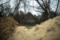 Old house in the village. Rural building. Sand on the background of the village Royalty Free Stock Photo