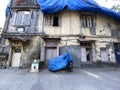 An old house with vintage windows and weathered walls in the suburb of Borivali.