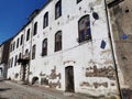 An old house with a white facade and beautifully shaped windows on a sunny summer day in Vyborg