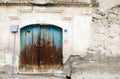 Old house white wall and aged blue woden door Royalty Free Stock Photo