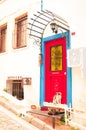 Old house white wall with blue and red door Royalty Free Stock Photo